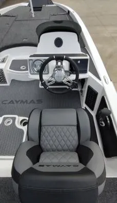 Slide: The Image of 2025 Caymas CX21 Pro boat interior with steering wheel and cushioned seating. - 6