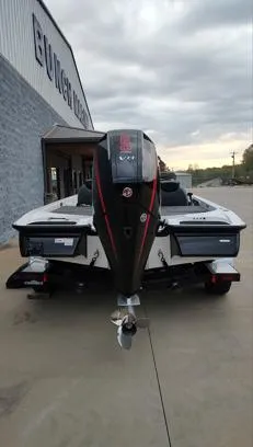 Slide: The Image of 2025 Caymas CX21 Pro boat, rear view, parked outdoors near a building. - 9