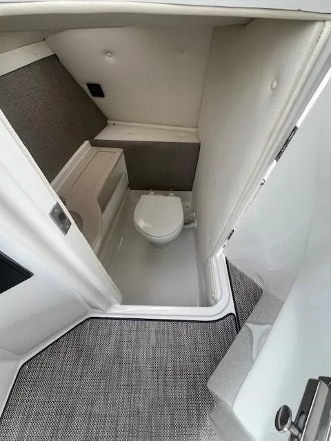 Slide: The Image of 2018 Cobalt R5 boat interior bathroom with modern design and compact toilet. - 10