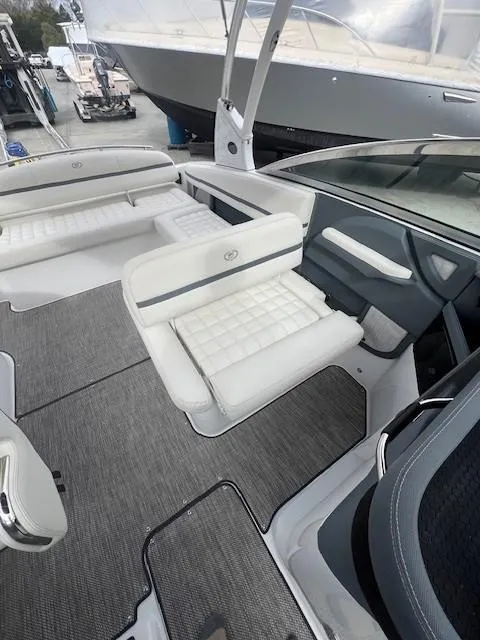 Slide: The Image of 2018 Cobalt R5 boat interior with white seating and gray flooring. - 11