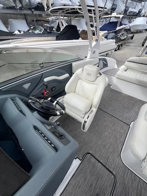 Slide: The Image of 2018 Cobalt R5 boat interior with white seating and modern dashboard. - 12
