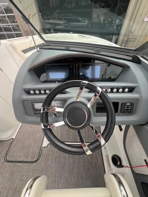 Slide: The Image of Cockpit of 2018 Cobalt R5 boat with modern steering wheel and dashboard controls. - 13