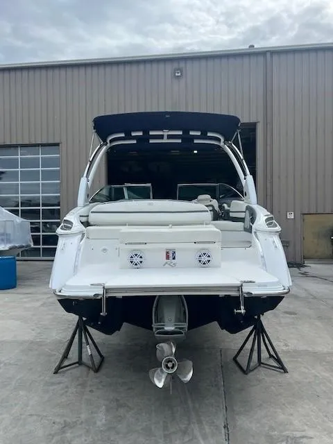 Slide: The Image of 2018 Cobalt R5 boat on stands, rear view, in front of a warehouse. - 3
