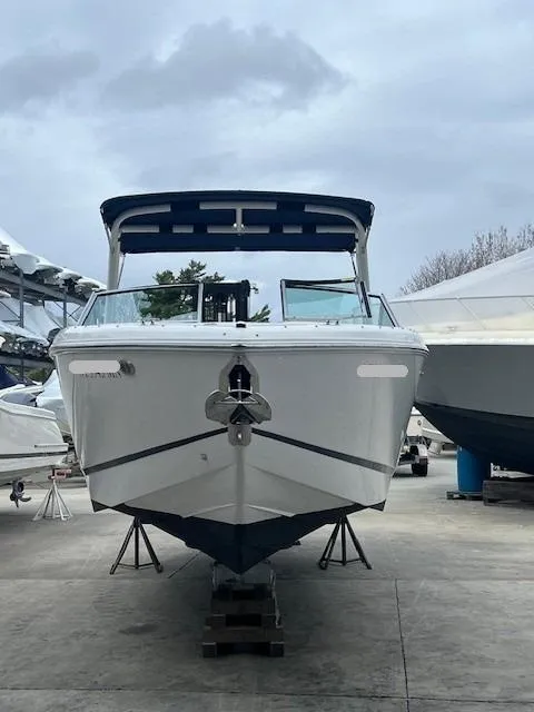 Slide: The Image of 2018 Cobalt R5 boat on display in a marina, overcast sky. - 5