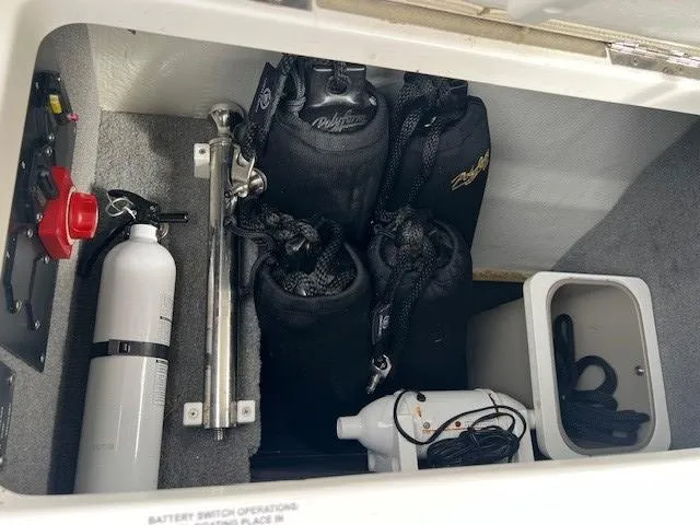 Slide: The Image of Storage compartment of 2018 Cobalt R5 boat with safety equipment and accessories. - 7