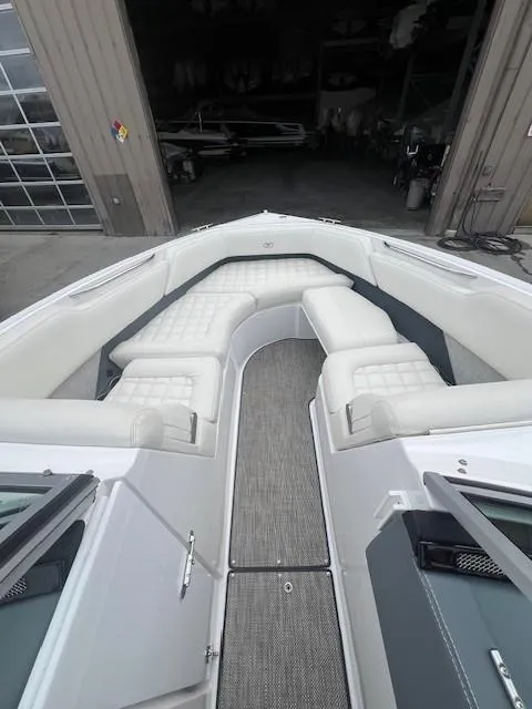 Slide: The Image of 2018 Cobalt R5 boat with white cushioned seating and gray flooring in a garage setting. - 9
