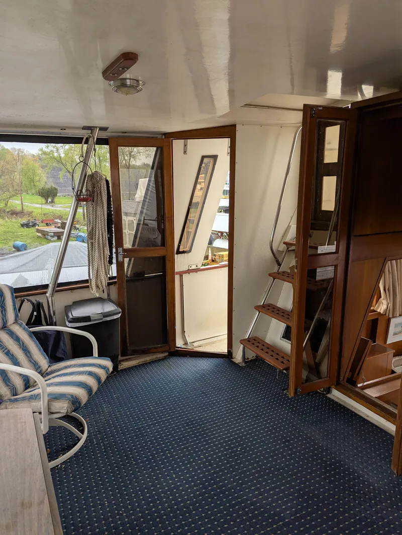 Slide: The Image of 1989 Jefferson 42 SE Sundeck Motor Yacht interior with striped chair and wooden accents. - 10