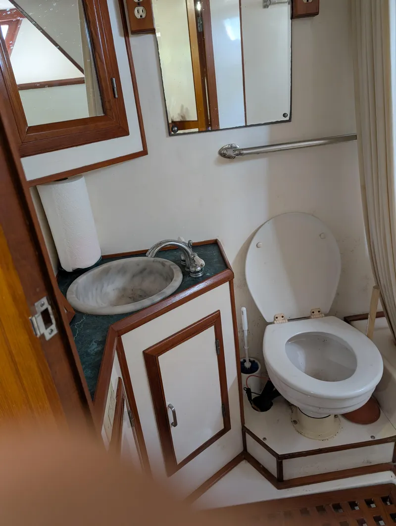 Slide: The Image of Bathroom interior of 1989 Jefferson 42 SE Sundeck Motor Yacht, featuring sink and toilet. - 16