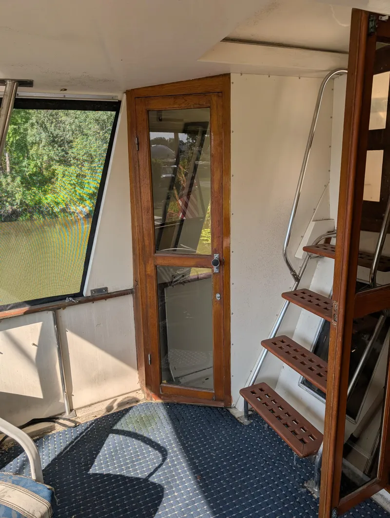 Slide: The Image of Interior of 1989 Jefferson 42 SE Sundeck Motor Yacht with wooden door and stairs. - 18