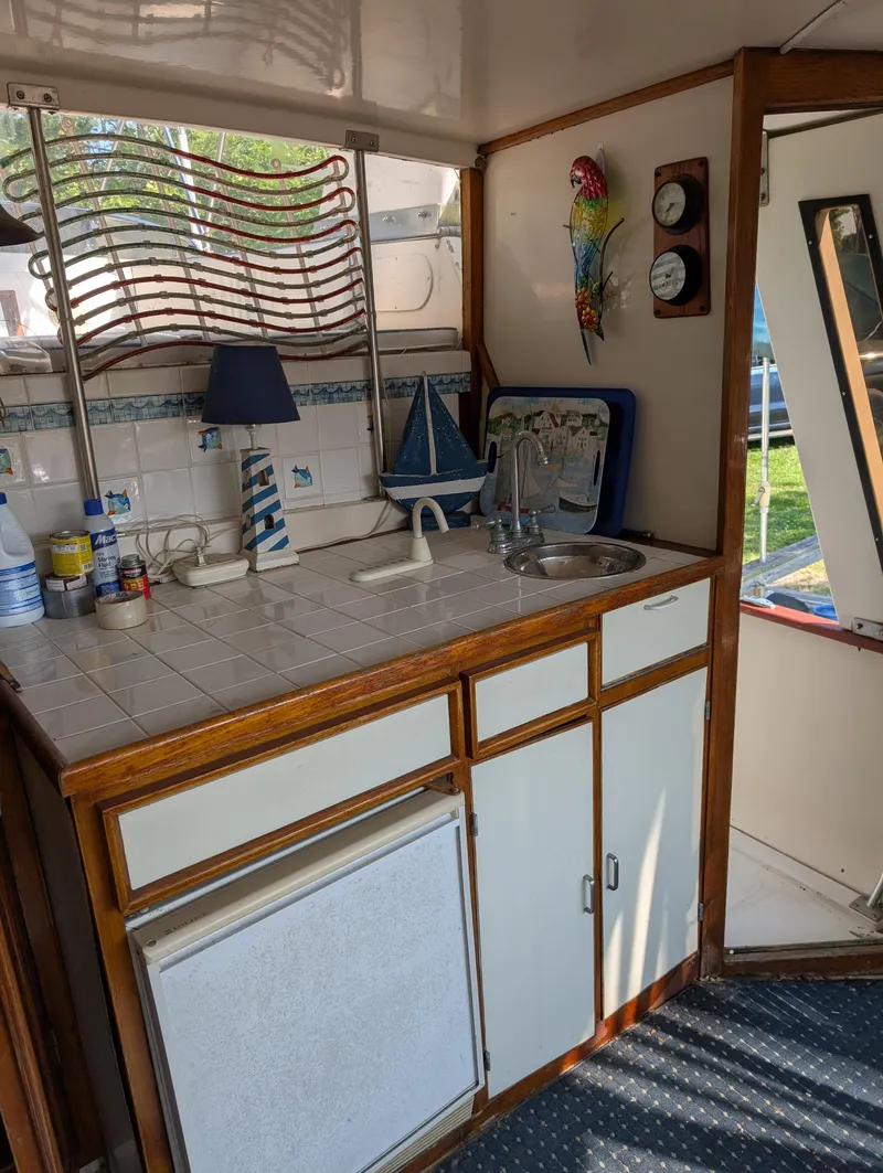 Slide: The Image of 1989 Jefferson 42 SE Sundeck Motor Yacht interior with kitchenette and nautical decor. - 19