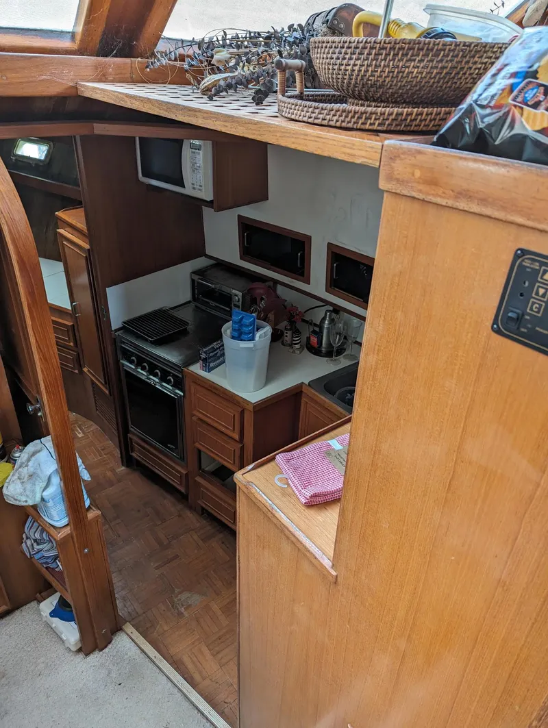 Slide: The Image of 1989 Jefferson 42 SE Sundeck Motor Yacht interior kitchen with wooden cabinetry and appliances. - 4