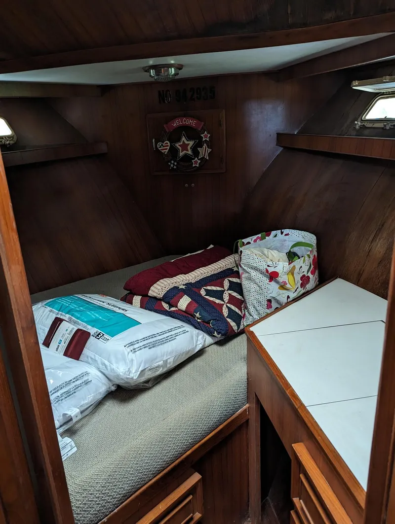 Slide: The Image of Cozy cabin interior of 1989 Jefferson 42 SE Sundeck Motor Yacht with bedding and storage. - 5