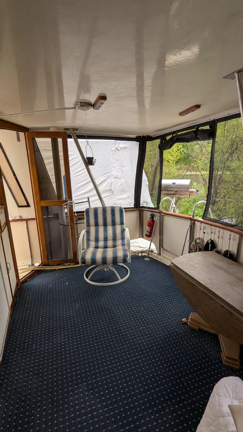 Slide: The Image of 1989 Jefferson 42 SE Sundeck Motor Yacht interior with striped chair and carpeted floor. - 8