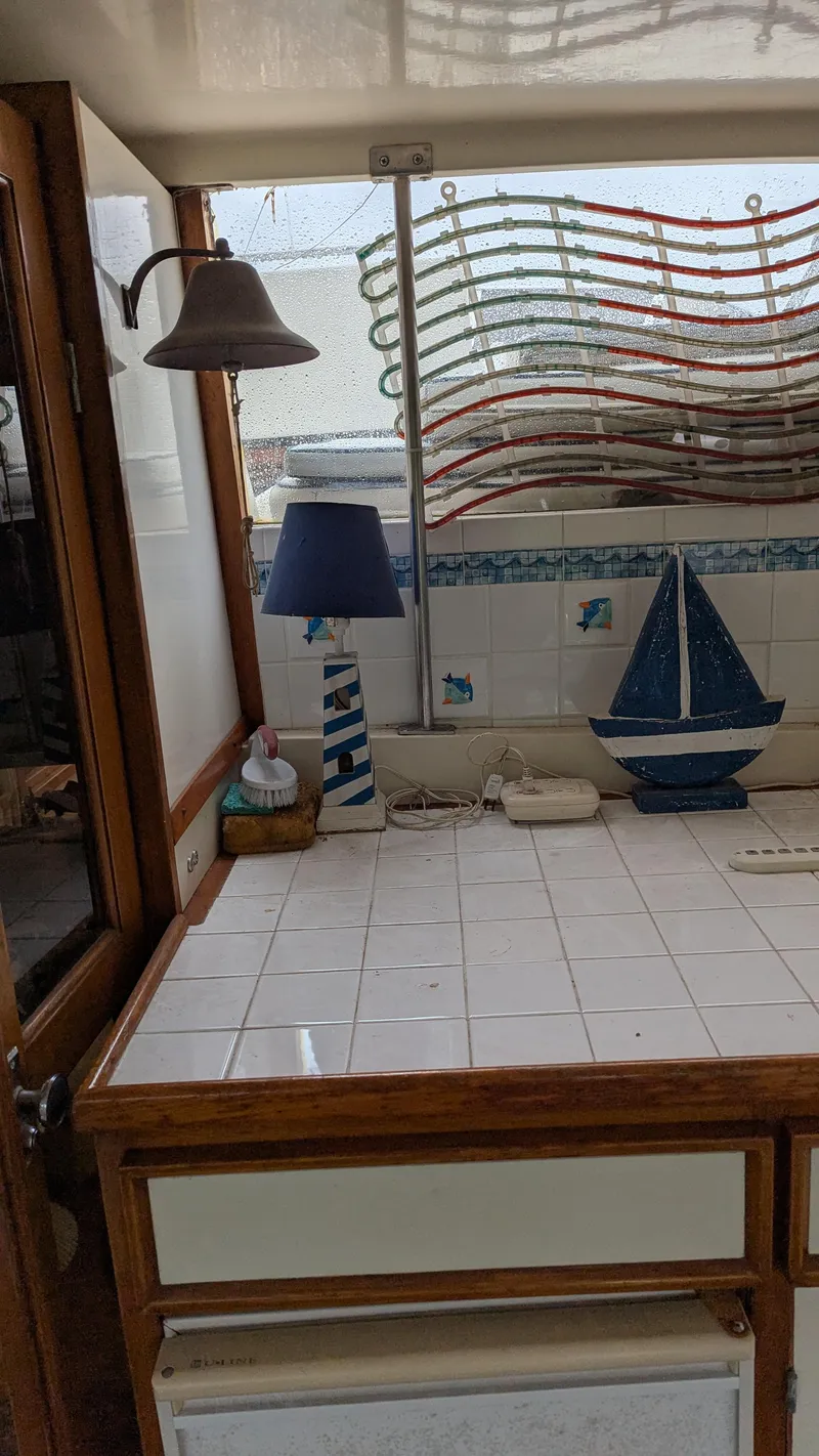 Slide: The Image of 1989 Jefferson 42 SE Sundeck Motor Yacht interior with nautical decor and tiled surfaces. - 9