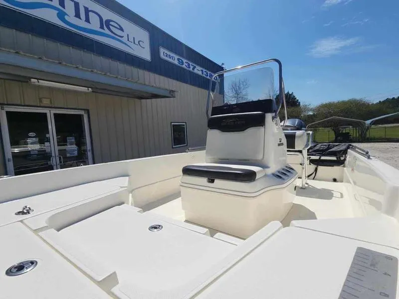 Slide: The Image of 2014 Skeeter SX2250 boat displayed outside a marine dealership under clear skies. - 10