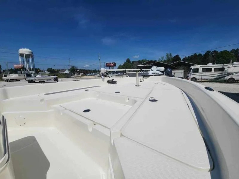 Slide: The Image of 2014 Skeeter SX2250 boat deck in a sunny outdoor setting, showcasing storage compartments. - 12