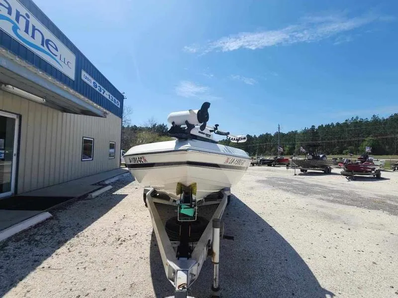 Slide: The Image of 2014 Skeeter SX2250 boat on trailer outside marine shop. - 2