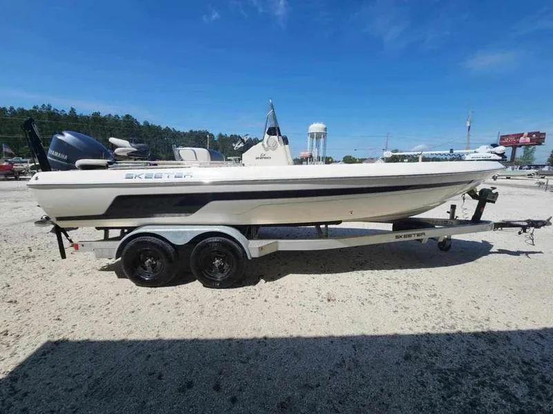 Slide: The Image of 2014 Skeeter SX2250 boat on trailer under clear blue sky. - 4