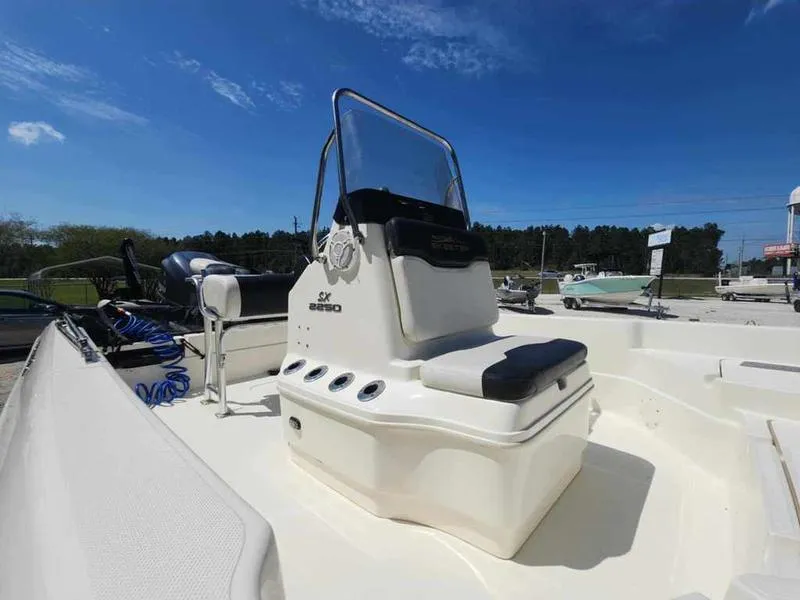 Slide: The Image of 2014 Skeeter SX2250 boat with center console under a clear blue sky. - 9