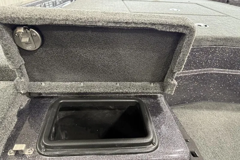 Slide: The Image of 2025 Skeeter ZX150 boat storage compartment with open lid, showcasing interior space. - 10
