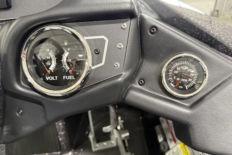 Slide: The Image of Dashboard of 2025 Skeeter ZX150 showing volt, fuel, and water pressure gauges. - 12