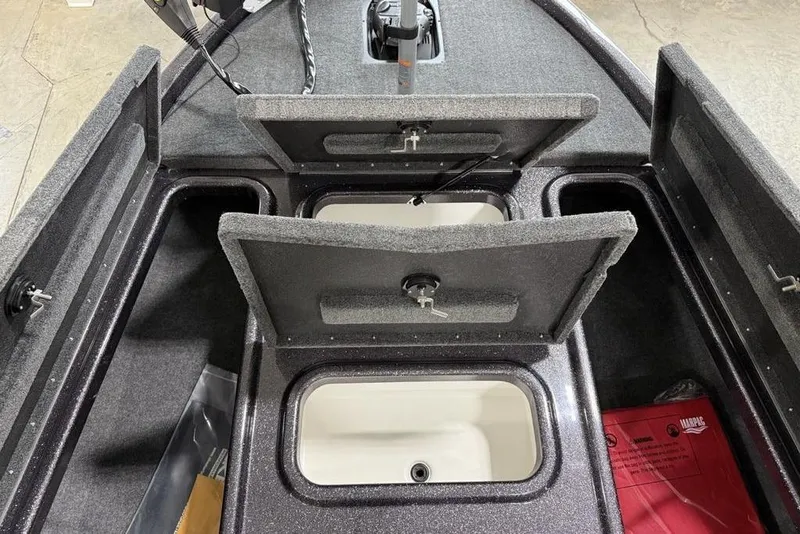 Slide: The Image of 2025 Skeeter ZX150 boat storage compartments with open lids, showcasing interior design. - 13