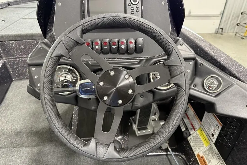 Slide: The Image of Steering wheel and dashboard of 2025 Skeeter ZX150 boat, featuring modern controls. - 15