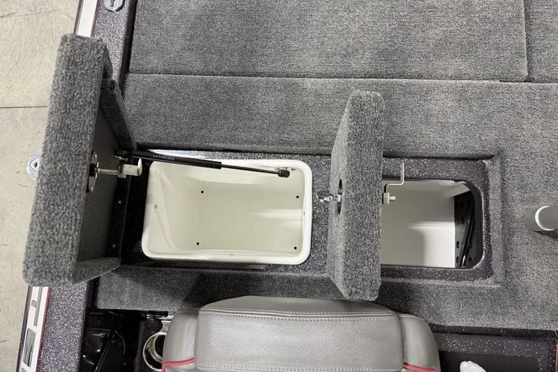 Slide: The Image of 2025 Skeeter ZX150 boat storage compartments with open lids, showcasing interior space. - 17