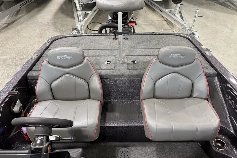 Slide: The Image of 2025 Skeeter ZX150 boat interior with two gray seats and steering wheel. - 23