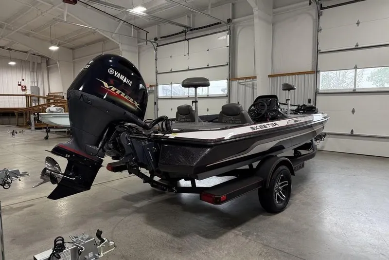 Slide: The Image of 2025 Skeeter ZX150 boat with Yamaha engine in a spacious garage setting. - 7