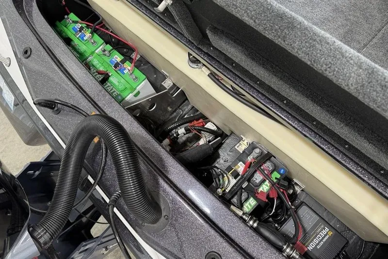 Slide: The Image of 2025 Skeeter ZX150 boat battery compartment with wiring and components. - 12