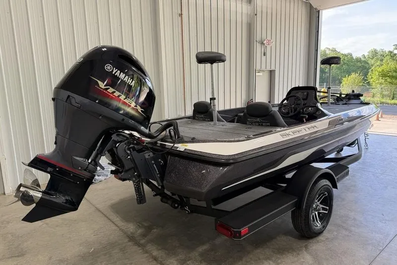 Slide: The Image of 2025 Skeeter ZX150 boat with Yamaha engine in a garage setting. - 4