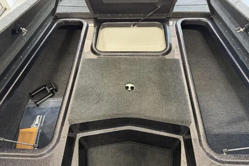 Slide: The Image of 2025 Skeeter ZX150 boat interior with storage compartments and carpeted flooring. - 7