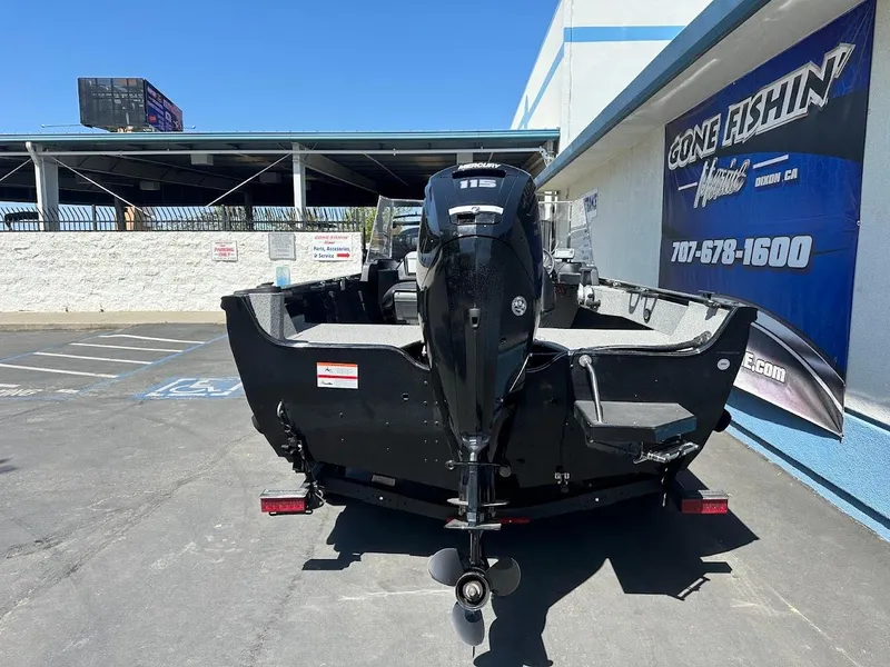 Slide: The Image of 2021 Crestliner 1700 Vision boat, black, parked outdoors near a fishing store. - 10