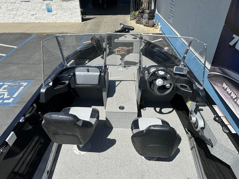 Slide: The Image of 2021 Crestliner 1700 Vision boat interior with dual seats and steering console. - 12