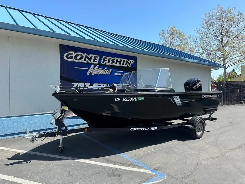 Slide: The Image of 2021 Crestliner 1700 Vision boat on trailer outside dealership. - 2