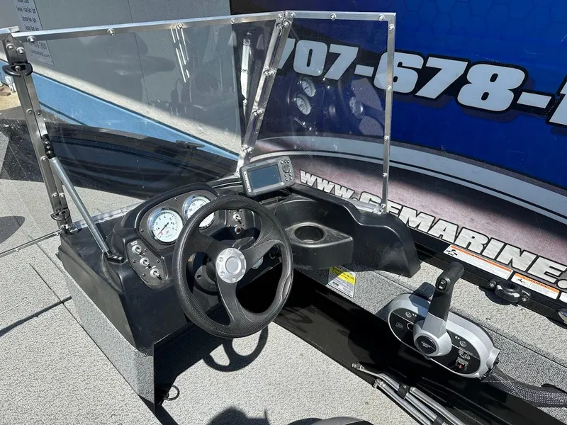 Slide: The Image of 2021 Crestliner 1700 Vision boat dashboard with steering wheel and gauges. - 21