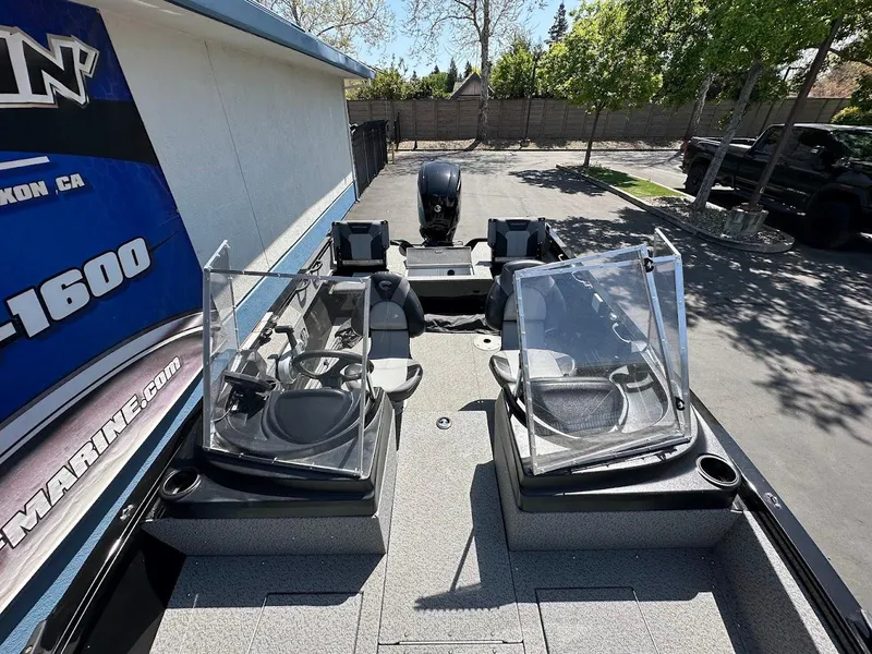 Slide: The Image of 2021 Crestliner 1700 Vision boat with dual consoles and seating, parked outdoors. - 30