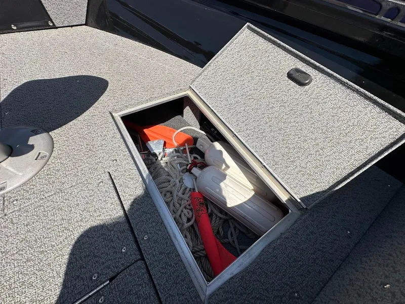 Slide: The Image of Storage compartment on 2021 Crestliner 1700 Vision boat with safety equipment and ropes. - 32
