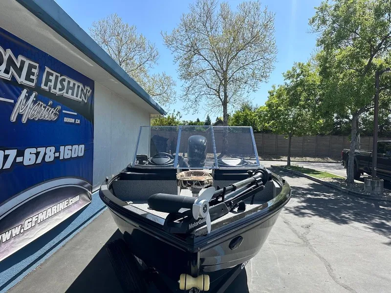 Slide: The Image of 2021 Crestliner 1700 Vision boat parked outdoors near a fishing store. - 4