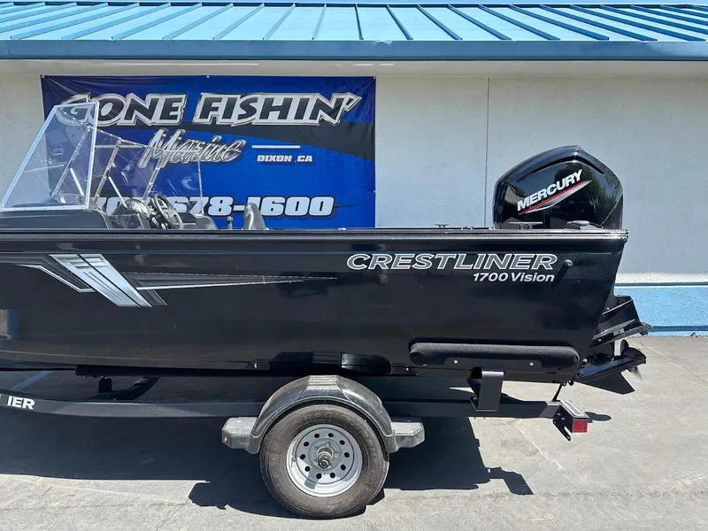 Slide: The Image of 2021 Crestliner 1700 Vision boat on trailer, featuring Mercury outboard motor. - 8