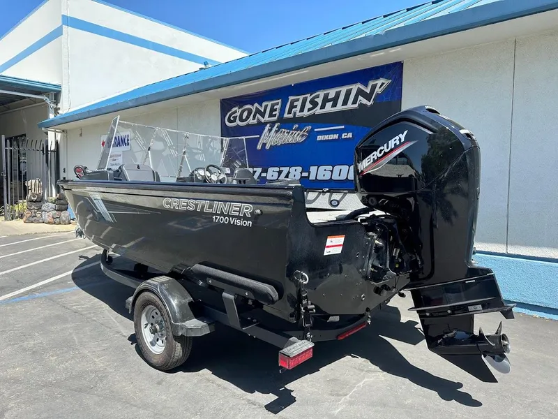 Slide: The Image of 2021 Crestliner 1700 Vision boat with Mercury engine, parked outside a dealership. - 9