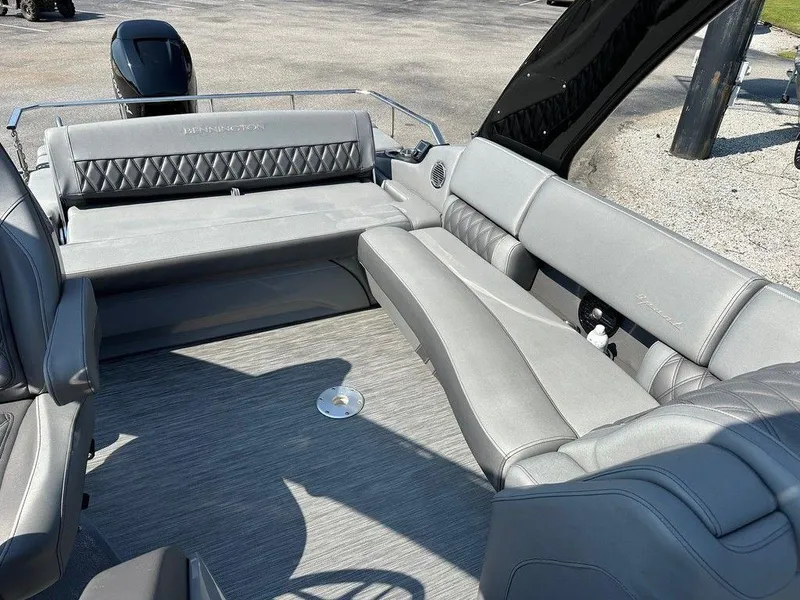 Slide: The Image of 2021 Bennington 25 RXSB boat interior with gray seating and modern design. - 11
