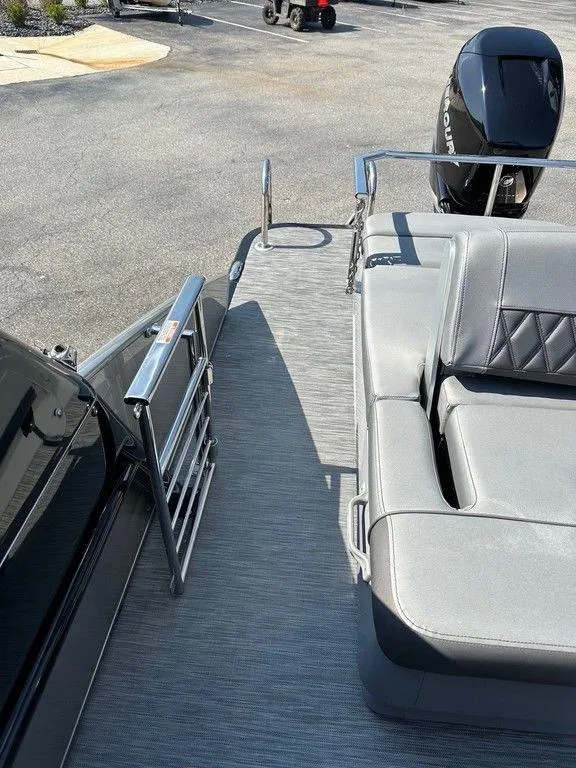 Slide: The Image of 2021 Bennington 25 RXSB pontoon boat with gray seating and Mercury outboard motor. - 13
