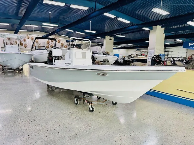 Slide: The Image of 2025 Frontier 180 boat displayed in a showroom with polished floors and overhead lighting. - 1