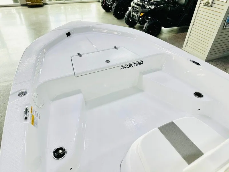 Slide: The Image of 2025 Frontier 180 boat interior, white deck with seating and storage compartments. - 2