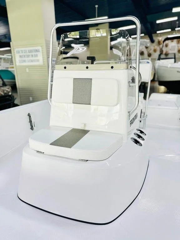 Slide: The Image of 2025 Frontier 180 boat console with seating, white and sleek design in showroom. - 4