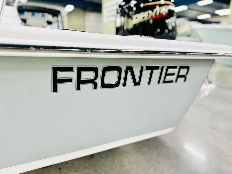 Slide: The Image of 2025 Frontier 180 boat side view with bold logo in showroom. - 5