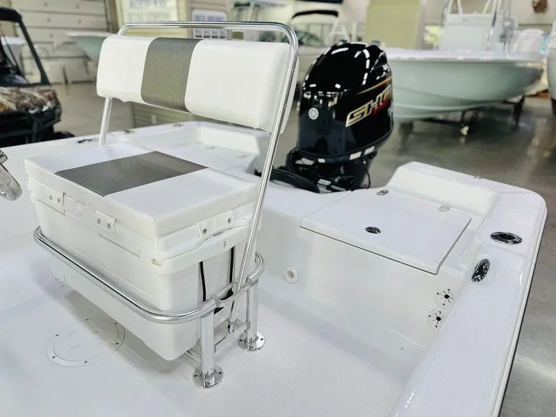 Slide: The Image of 2025 Frontier 180 boat interior with seating and outboard motor in showroom. - 6