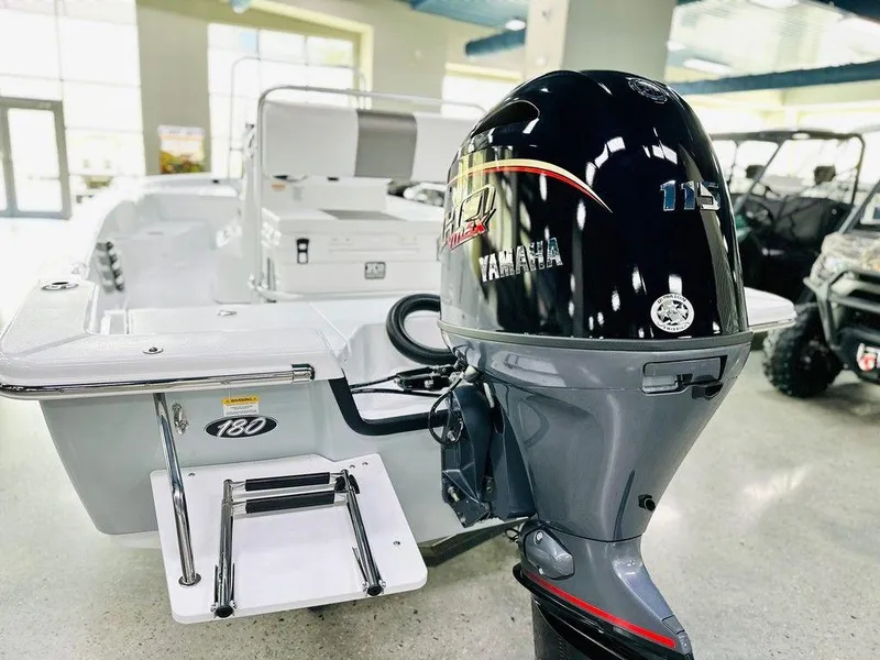 Slide: The Image of 2025 Frontier 180 boat with Yamaha 115 outboard motor in showroom. - 7
